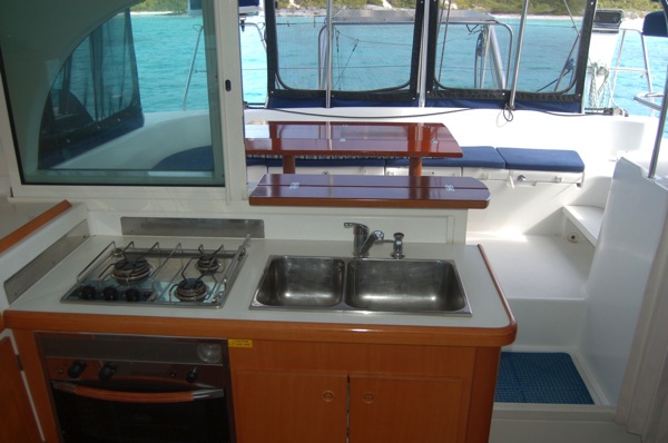 Galley opens to cockpit. Keep room cool and gives the chef an opportunity to socialize while cooking.